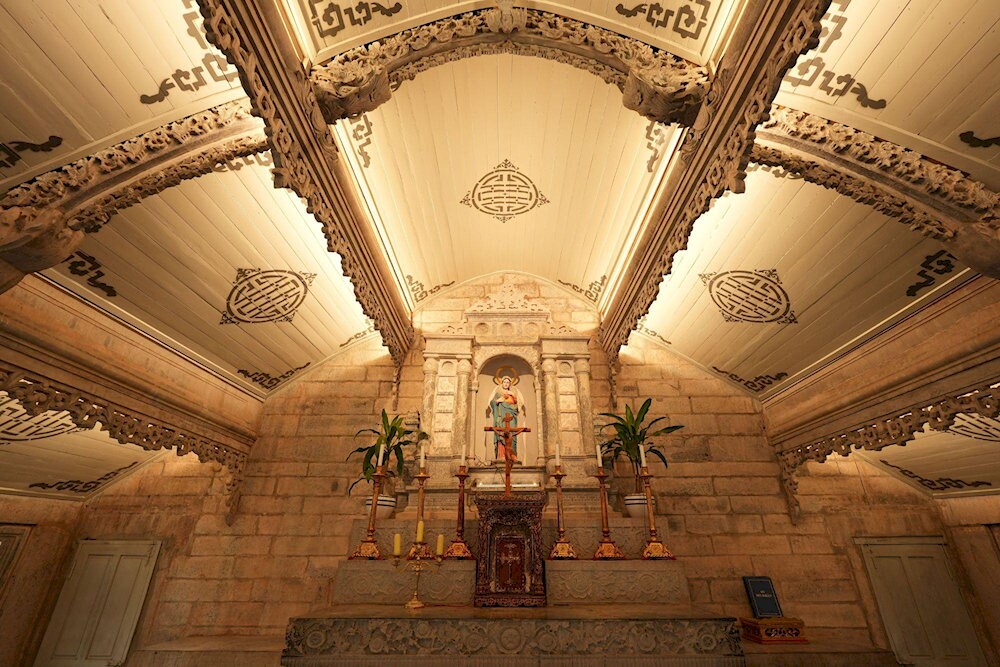 The intricately carved stone altar in the Church of the Sacred Heart features statues of the Virgin Mary